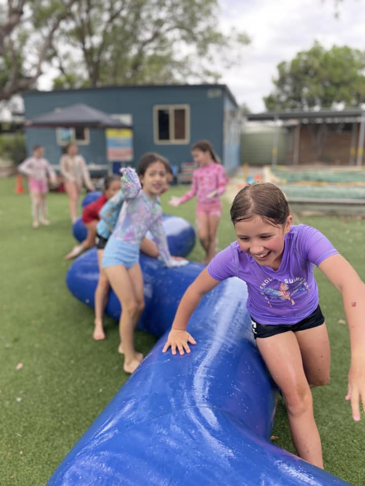 Students on inflatable obstacle course