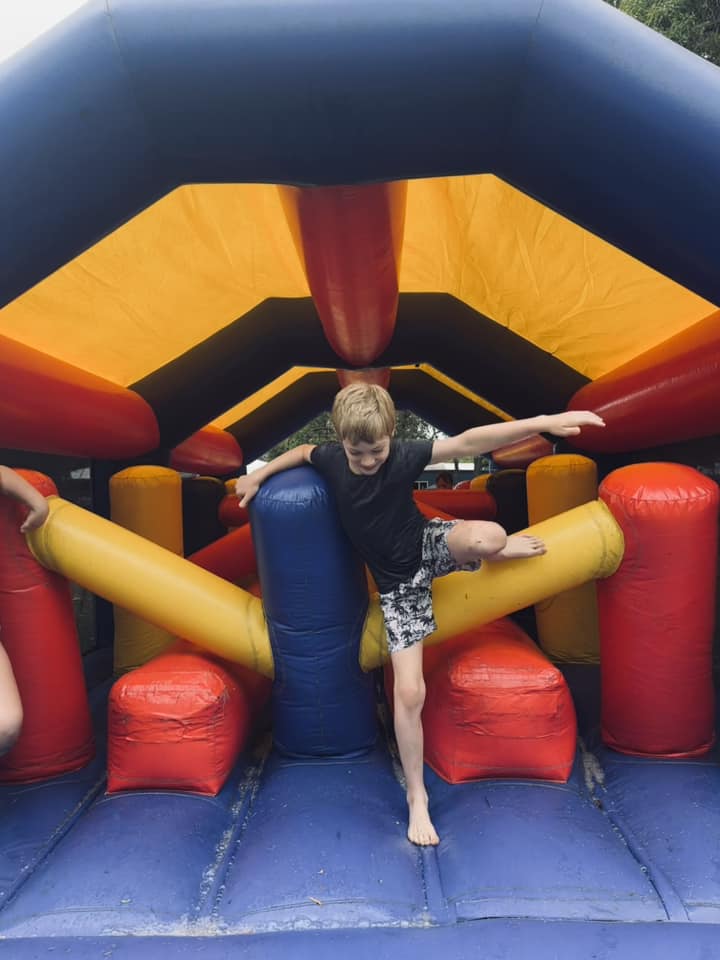 Student on inflatable obstacle