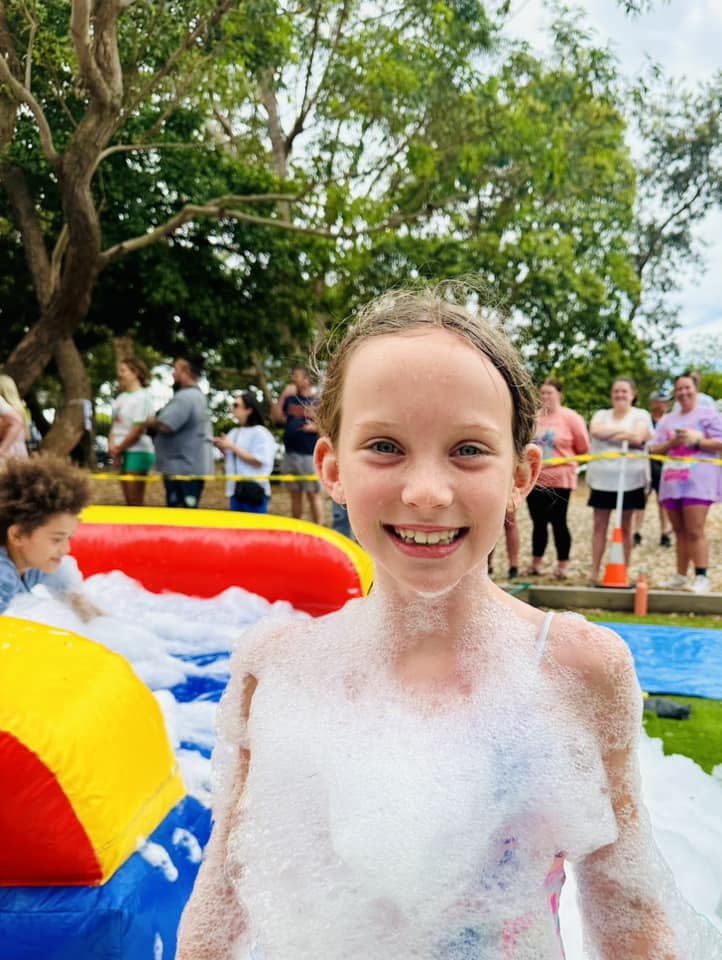 Girl covered in foam smiling