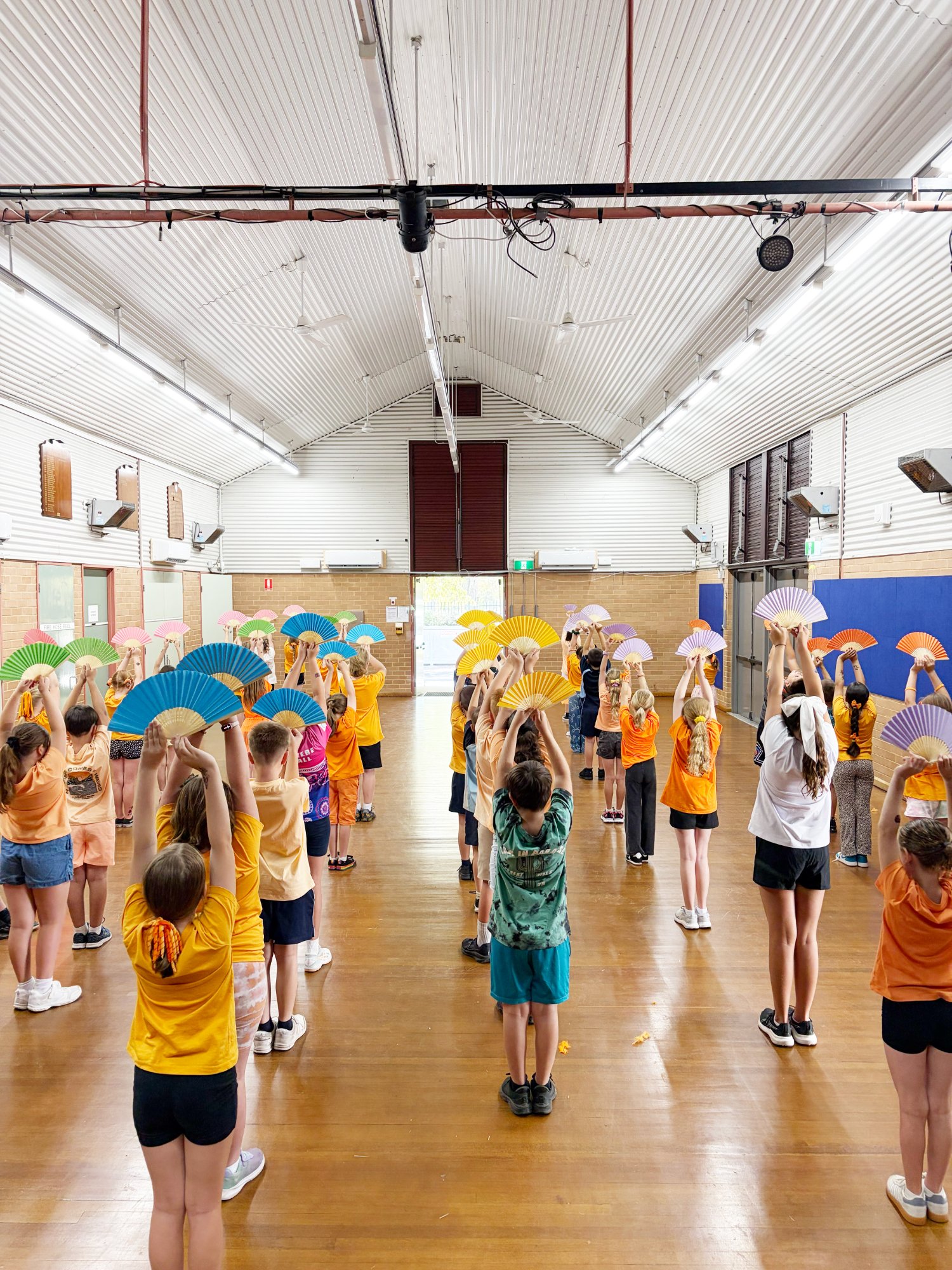 Students with colourful fans in dance workshop