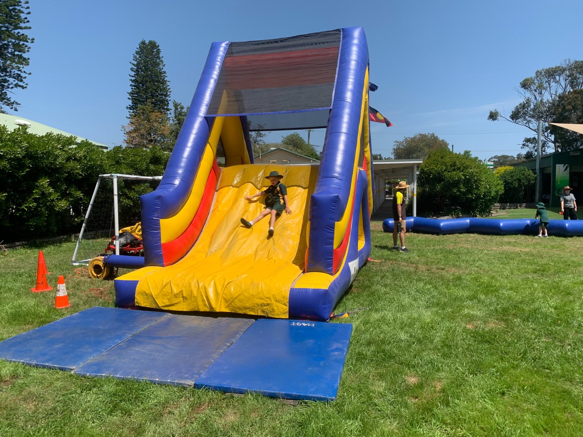 Kid sliding down inflatable slide at school event