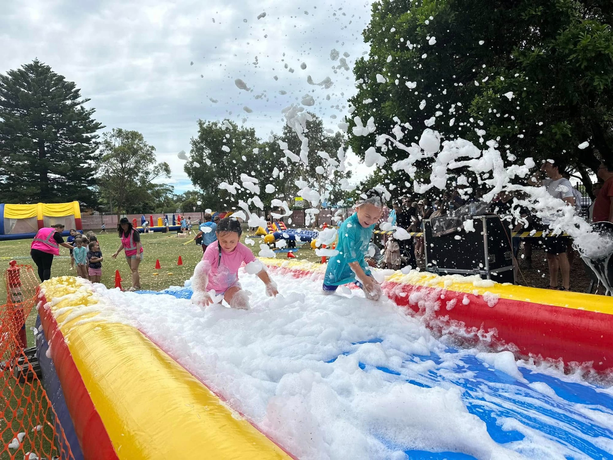 Kids playing in foam splash zone