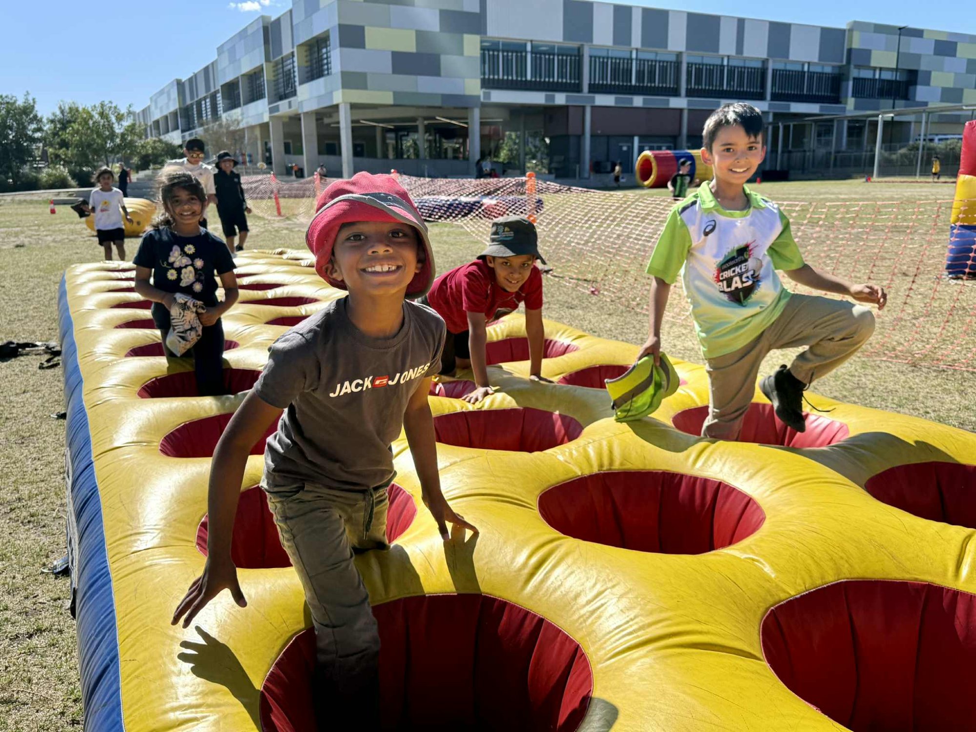 Kids on inflatable obstacle course